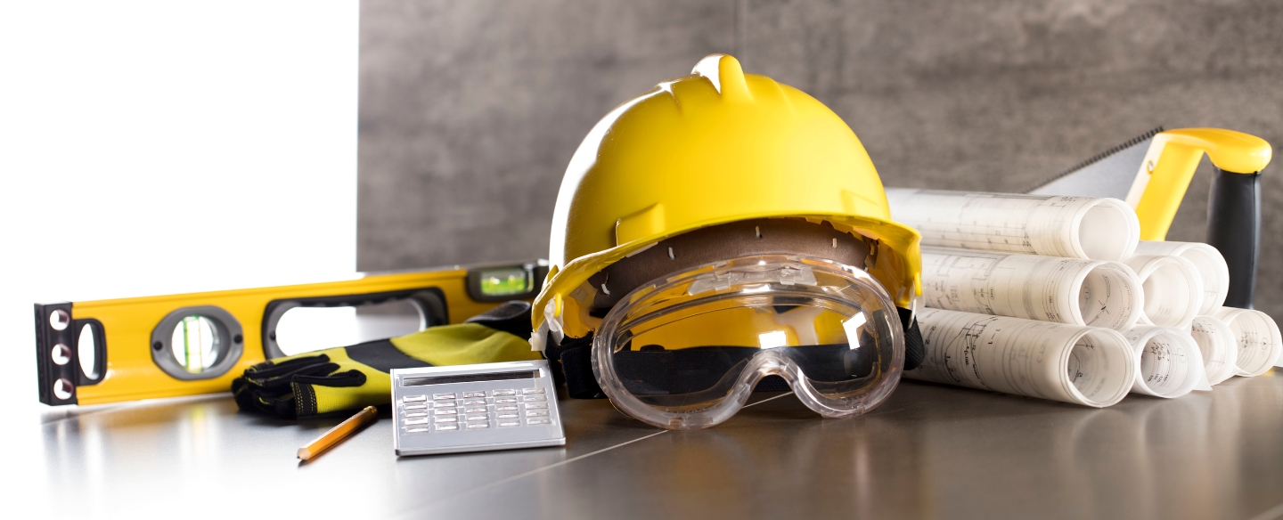 yellow helmet with some blueprints and tools on table courtland ms